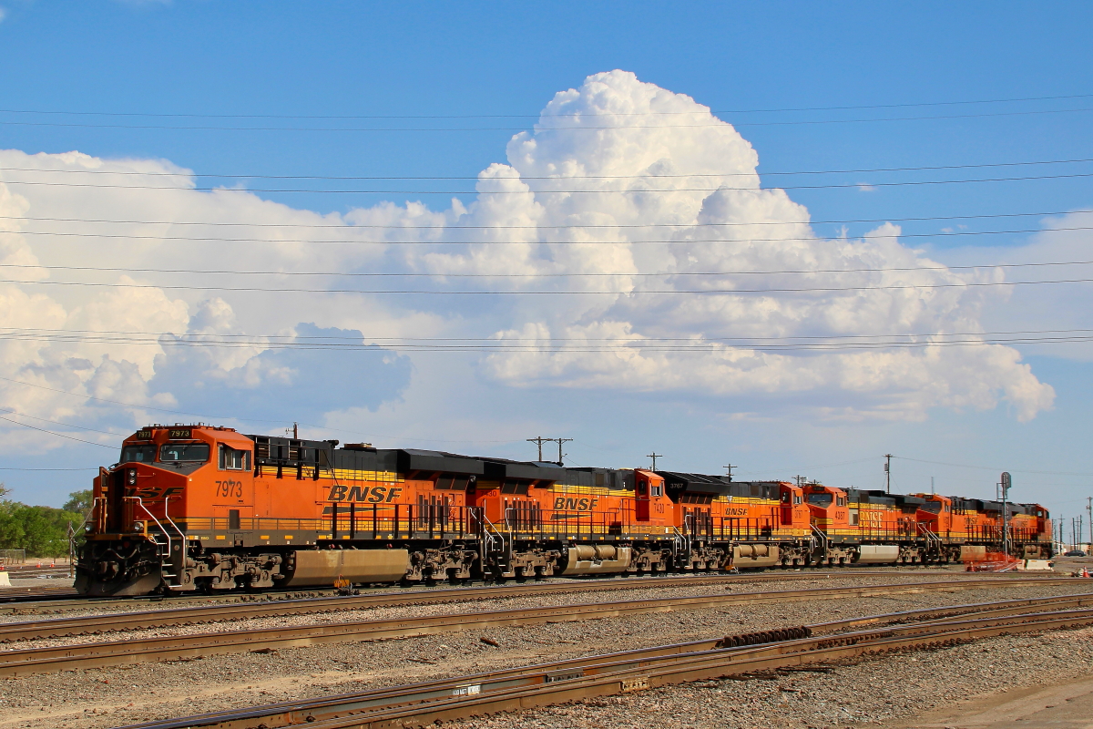 BNSF 7973 is a class GE ES44C4 and  is pictured in Belen, New Mexico, USA.  This was taken along the Belen/BNSF on the BNSF Railway. Photo Copyright: Rick Doughty uploaded to Railroad Gallery on 12/10/2023. This photograph of BNSF 7973 was taken on Saturday, July 10, 2021. All Rights Reserved. 