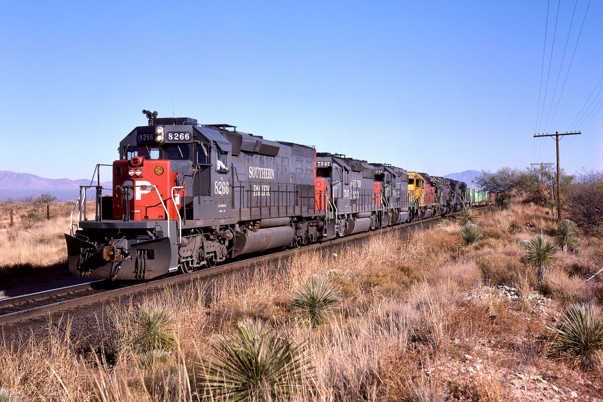 SP 8266 is a class EMD SD40T-2 and  is pictured in Mescal, Arizona, USA.  This was taken along the Lordsburg/SP on the Southern Pacific Transportation Company. Photo Copyright: Rick Doughty uploaded to Railroad Gallery on 04/04/2024. This photograph of SP 8266 was taken on Saturday, December 26, 1987. All Rights Reserved. 