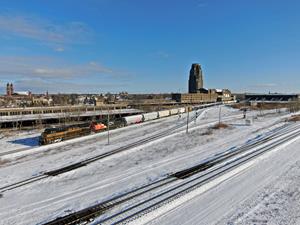 Q567-02 is led by Norfolk Southern's Nickle Plate Heritage unit as it passes Buffalo's Central Terminal.