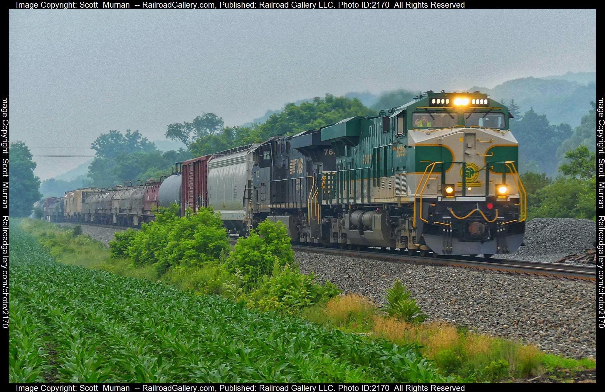 NS 8099 is a class GE ES44AC and  is pictured in Canaseraga , New York, United States.  This was taken along the Southern Tier Line on the Norfolk Southern. Photo Copyright: Scott  Murnan  uploaded to Railroad Gallery on 06/28/2023. This photograph of NS 8099 was taken on Wednesday, June 28, 2023. All Rights Reserved. 