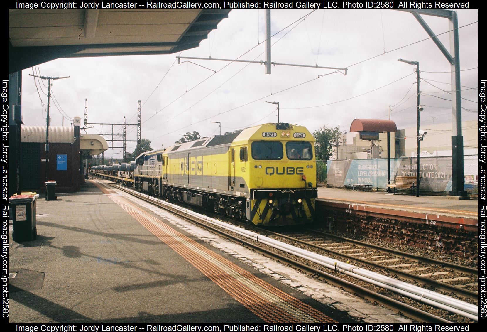 QUB G521 + RFAM VL360 is a class JT26C-2SS + GT26C and  is pictured in Glen Huntly, VIC, Australia.  This was taken along the Frankston on the Qube Logistics. Photo Copyright: Jordy Lancaster uploaded to Railroad Gallery on 12/05/2023. This photograph of QUB G521 + RFAM VL360 was taken on Wednesday, March 29, 2023. All Rights Reserved. 