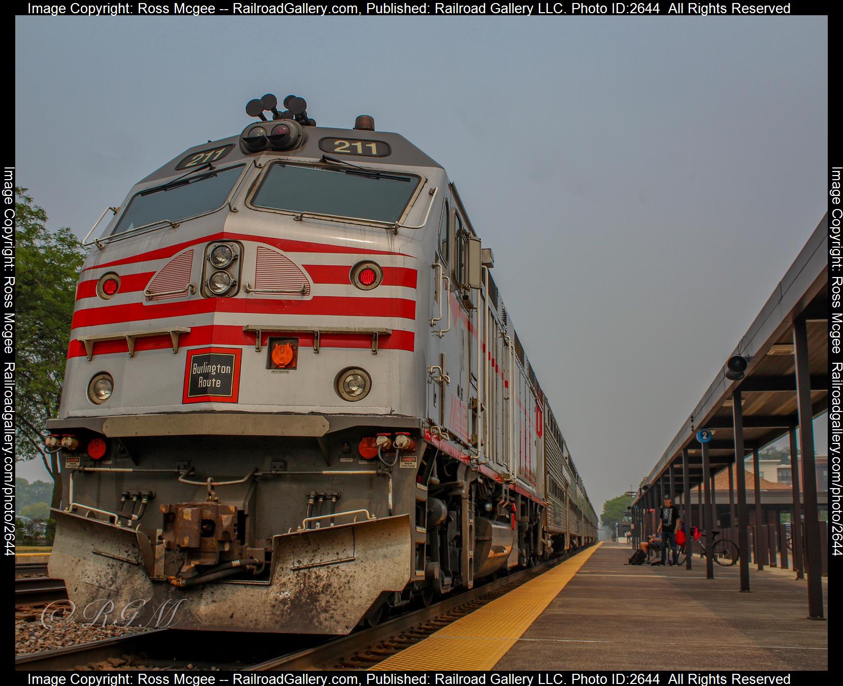 METX #211 is a class EMD F40PHM and  is pictured in Napervillie, Illinois, USA.  This was taken along the BNSF Racetrack on the Metra. Photo Copyright: Ross Mcgee uploaded to Railroad Gallery on 12/12/2023. This photograph of METX #211 was taken on Tuesday, June 27, 2023. All Rights Reserved. 