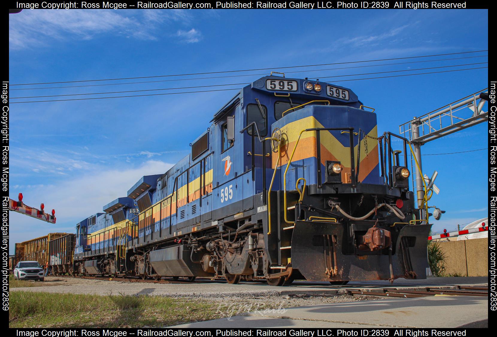 SGLR 595 is a class GE B39-8 (Dash 8-39B) and  is pictured in Punta Gorda, Florida, USA.  This was taken along the Fort Myers Subdivision on the Seminole Gulf Railway. Photo Copyright: Ross Mcgee uploaded to Railroad Gallery on 12/31/2023. This photograph of SGLR 595 was taken on Friday, December 29, 2023. All Rights Reserved. 