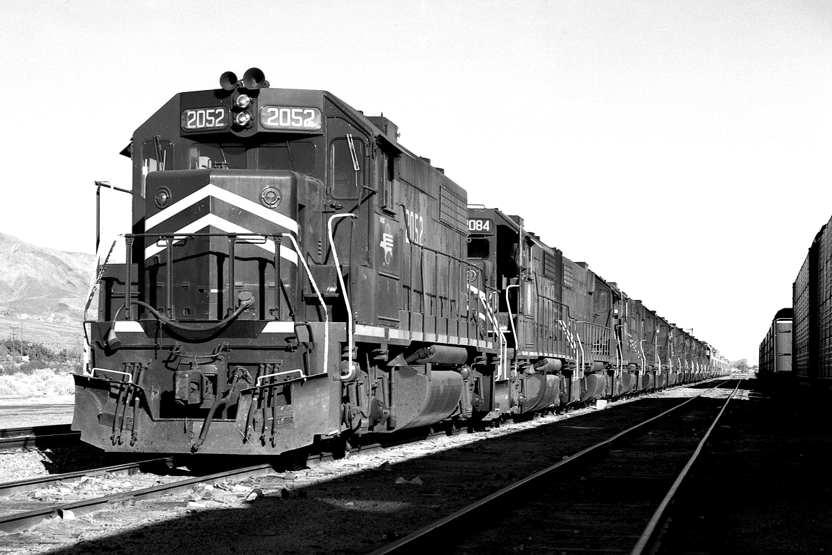 MP 2052 is a class EMD GP38-2 and  is pictured in Yermo, California, USA.  This was taken along the Yermo/UP on the Missouri Pacific Railroad. Photo Copyright: Rick Doughty uploaded to Railroad Gallery on 01/04/2024. This photograph of MP 2052 was taken on Saturday, November 30, 1985. All Rights Reserved. 