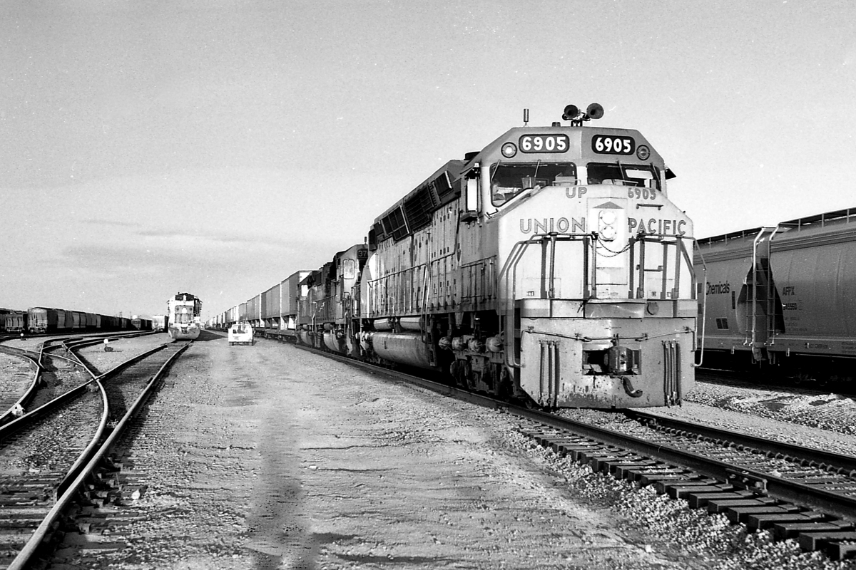 UP 6905 is a class EMD DD40X and  is pictured in Yermo, California, USA.  This was taken along the Las Vegas/UP on the Union Pacific Railroad. Photo Copyright: Rick Doughty uploaded to Railroad Gallery on 01/19/2024. This photograph of UP 6905 was taken on Saturday, February 04, 1984. All Rights Reserved. 