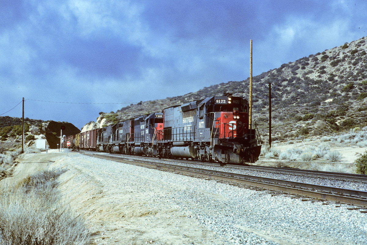 SP 9177 is a class EMD SD45T-2 and  is pictured in Summit, California, USA.  This was taken along the Cajon/SP on the Southern Pacific Transportation Company. Photo Copyright: Rick Doughty uploaded to Railroad Gallery on 01/29/2024. This photograph of SP 9177 was taken on Saturday, February 09, 1985. All Rights Reserved. 