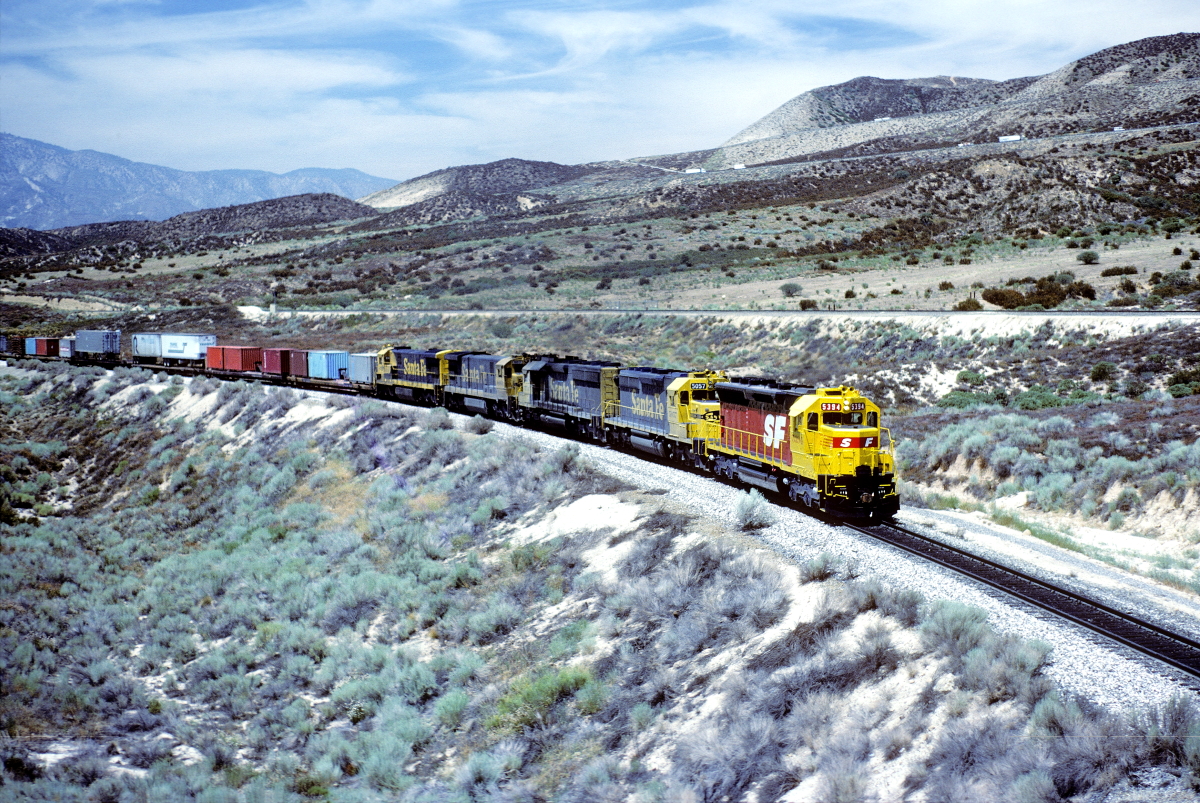 SF 5394 is a class EMD SD45 and  is pictured in Summit, California, USA.  This was taken along the Cajon/SF on the Santa Fe. Photo Copyright: Rick Doughty uploaded to Railroad Gallery on 01/30/2024. This photograph of SF 5394 was taken on Saturday, September 07, 1985. All Rights Reserved. 