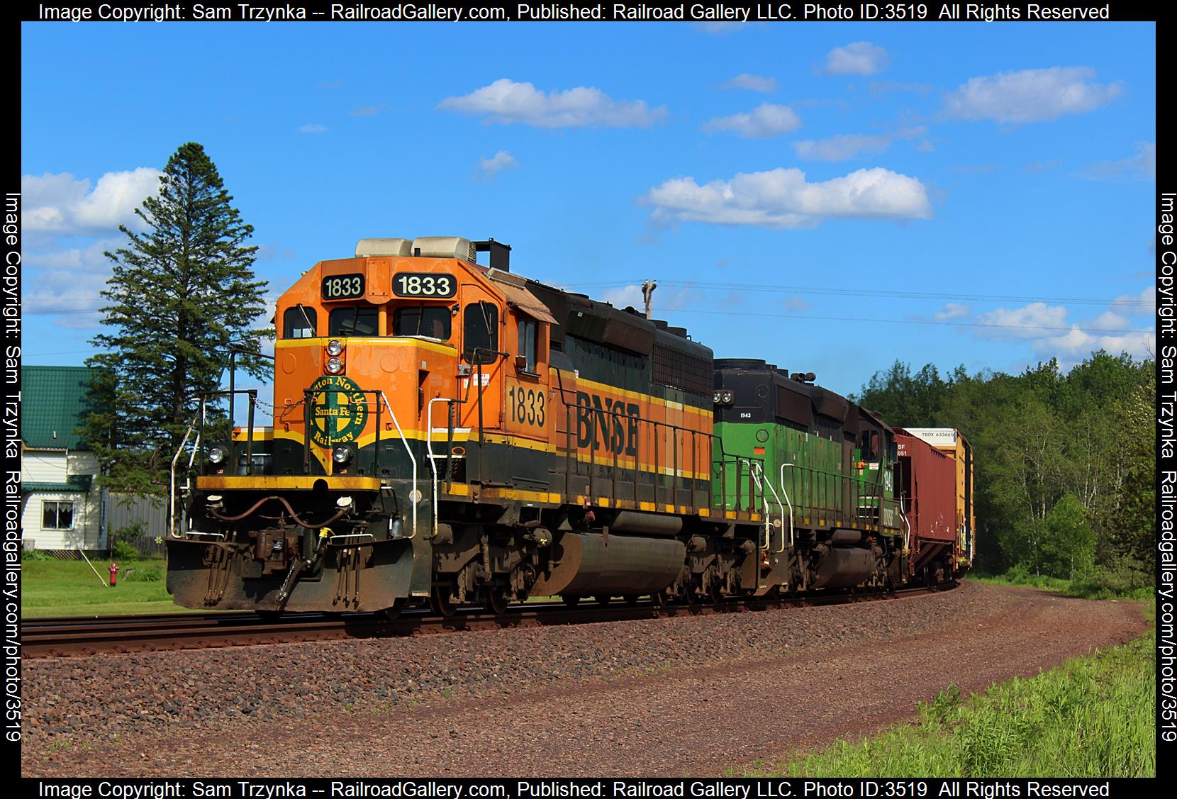 BNSF 1833 is a class EMD SD40-2 and  is pictured in Carlton, Minnesota, USA.  This was taken along the BNSF Lakes Subdivision on the BNSF Railway. Photo Copyright: Sam Trzynka uploaded to Railroad Gallery on 06/17/2024. This photograph of BNSF 1833 was taken on Friday, June 07, 2024. All Rights Reserved. 