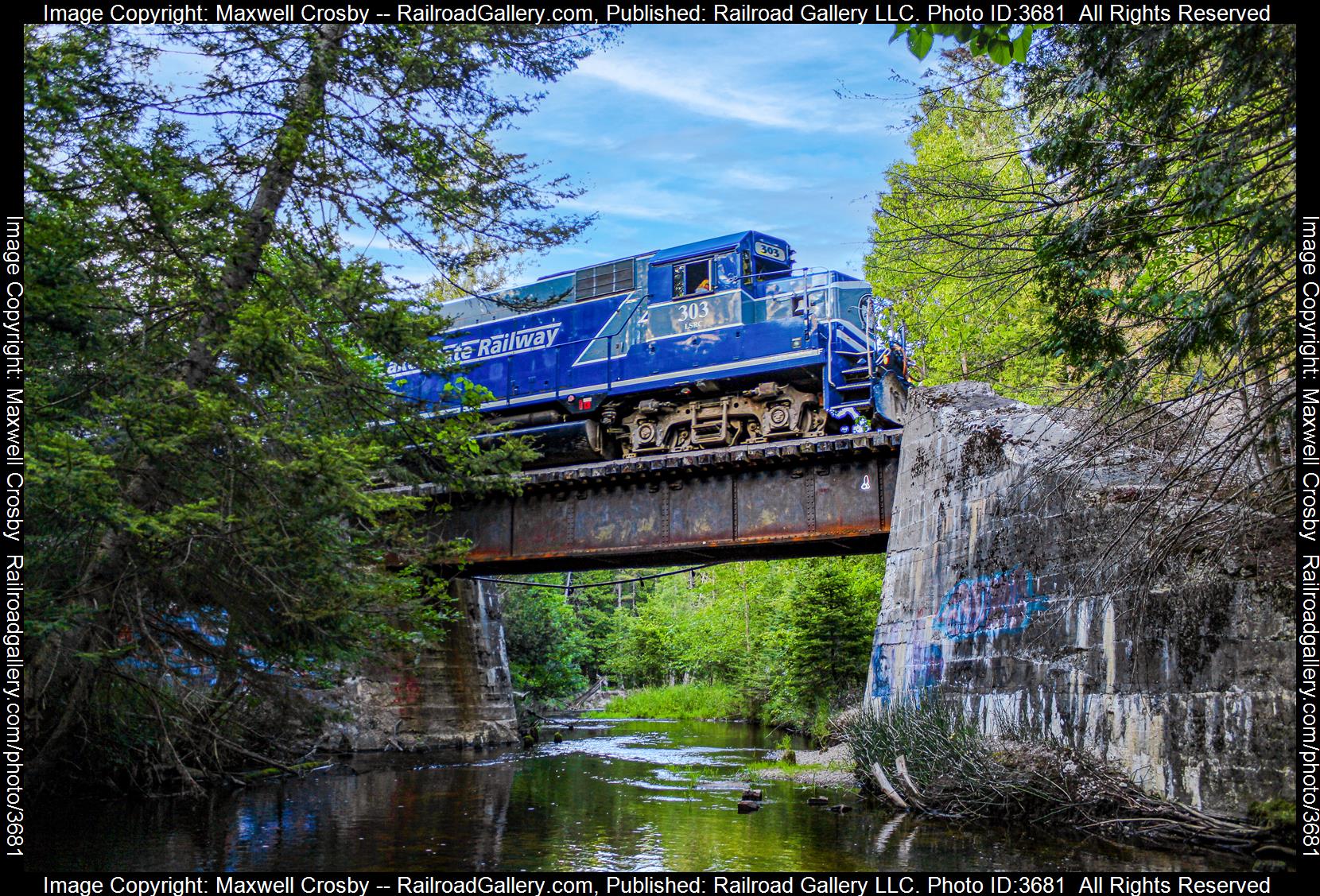 LSRC #303 is a class EMD GP35 Slug and  is pictured in Ossineke, Michigan, United States.  This was taken along the Huron Subdivision on the Lake State Railway. Photo Copyright: Maxwell Crosby uploaded to Railroad Gallery on 08/16/2024. This photograph of LSRC #303 was taken on Thursday, July 18, 2024. All Rights Reserved. 