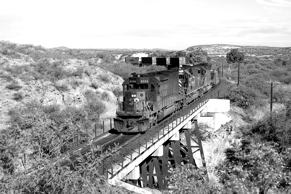 SP 8568 is a class EMD SD40T-2 and  is pictured in Vail, Arizona, USA.  This was taken along the Lordsburg/SP on the Southern Pacific Transportation Company. Photo Copyright: Rick Doughty uploaded to Railroad Gallery on 09/02/2024. This photograph of SP 8568 was taken on Sunday, September 23, 1990. All Rights Reserved. 