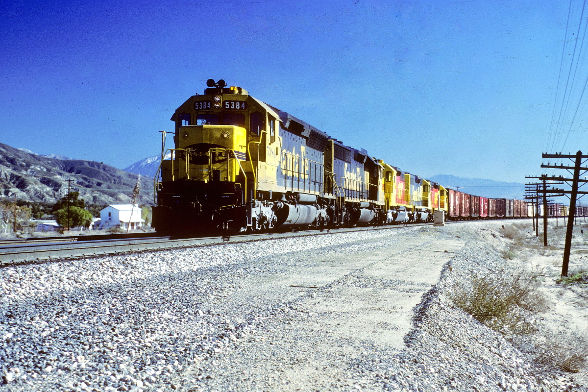 SF 5384 is a class EMD SD45 and  is pictured in Devore, California, USA.  This was taken along the Cajon/UP on the Santa Fe. Photo Copyright: Rick Doughty uploaded to Railroad Gallery on 10/09/2024. This photograph of SF 5384 was taken on Saturday, December 07, 1985. All Rights Reserved. 