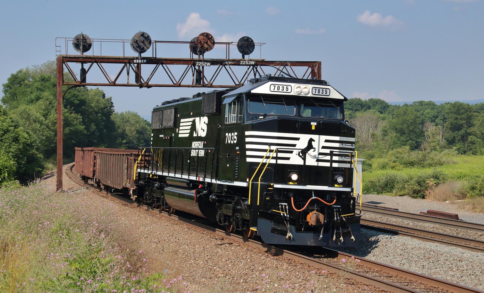 NS 7035 is a class EMD SD60E and  is pictured in Tipton, Pennsylvania, USA.  This was taken along the NS Pittsburgh Line on the Norfolk Southern. Photo Copyright: Marc Lingenfelter uploaded to Railroad Gallery on 01/08/2023. This photograph of NS 7035 was taken on Wednesday, July 19, 2017. All Rights Reserved. 