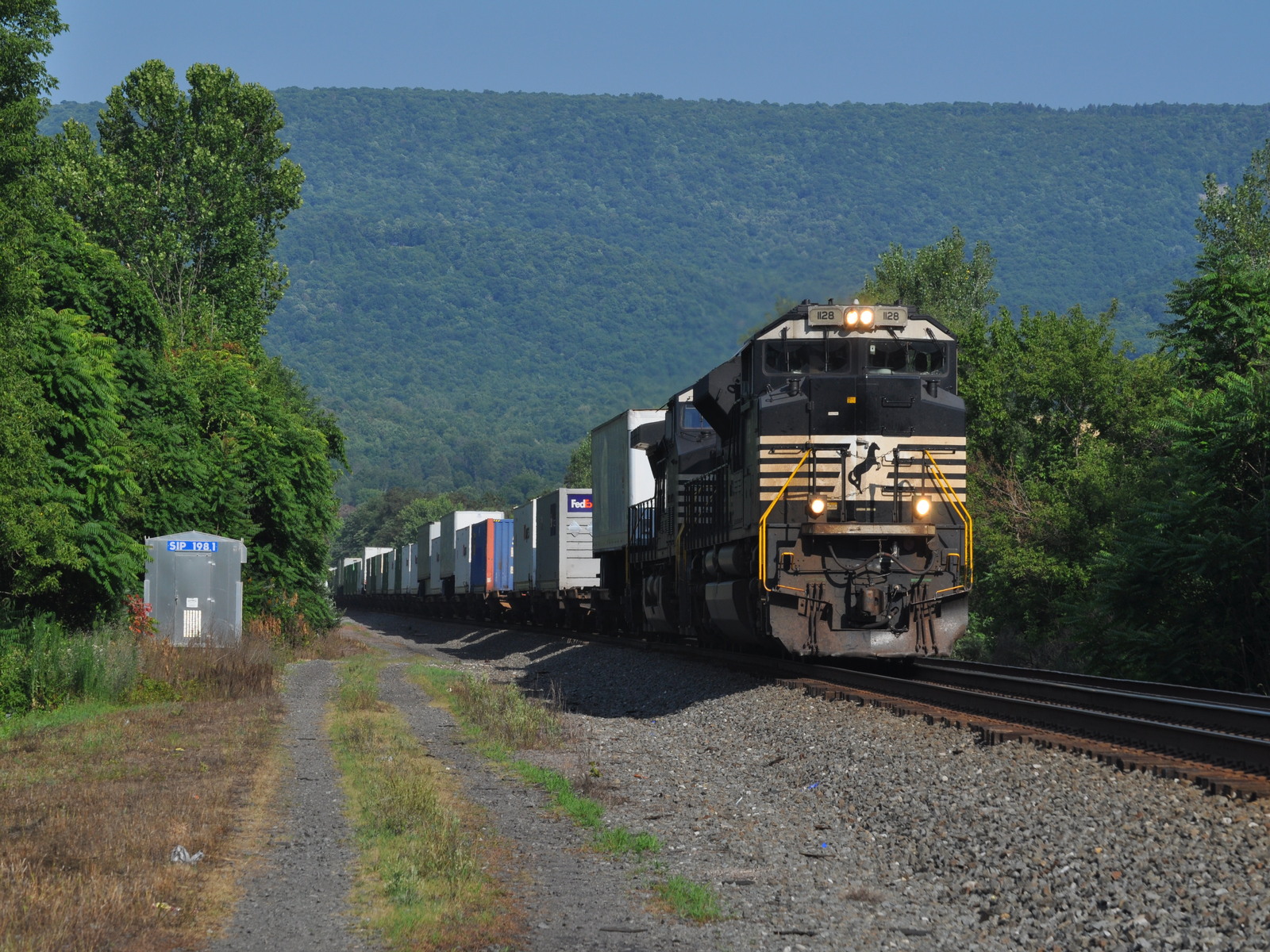 NS 1128 is a class EMD SD70ACe and  is pictured in Huntington, Pennsylvania, United States.  This was taken along the NS Pittsburgh line on the Norfolk Southern. Photo Copyright: Robby Lefkowitz uploaded to Railroad Gallery on 11/12/2022. This photograph of NS 1128 was taken on Friday, July 22, 2022. All Rights Reserved. 